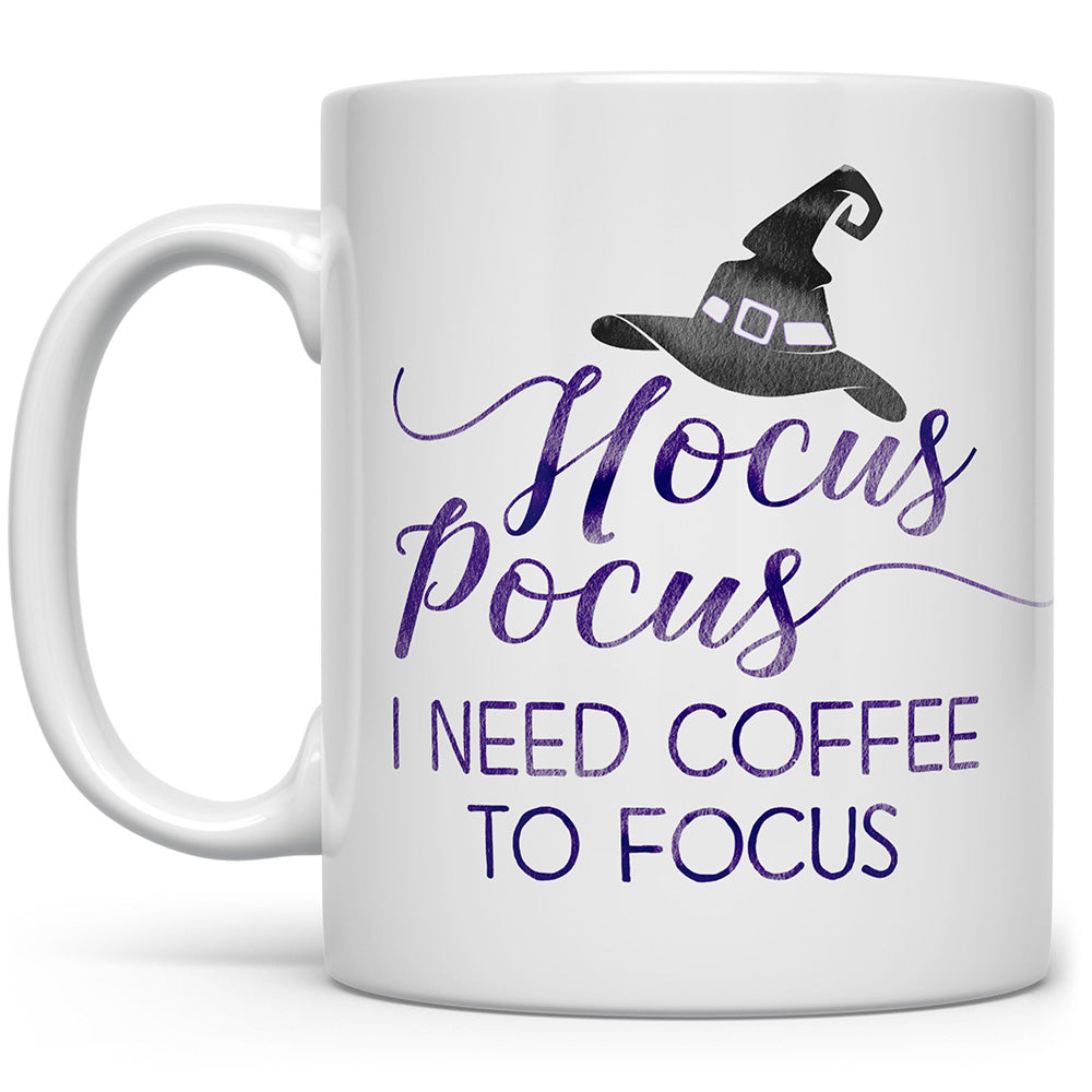 White mug that says hocus pocus I need coffee to focus with black witches hat on a white background