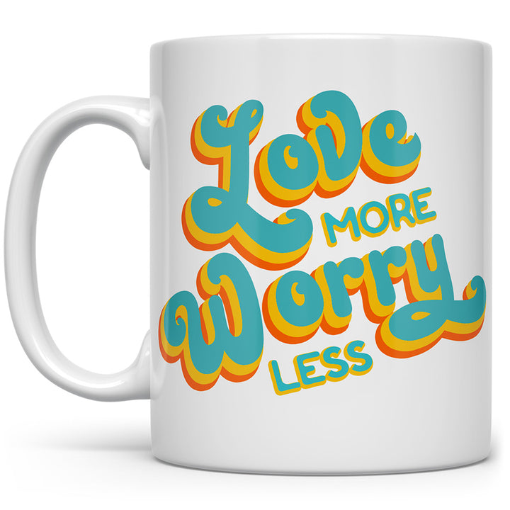 White mug that says Love More, Worry Less in blue and yellow text