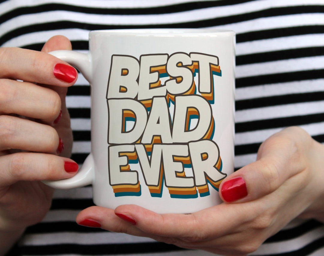Best Dad Ever Mug held by woman in black and white top with red nail polish