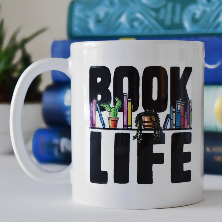 Book Life Mug on a table in front of books