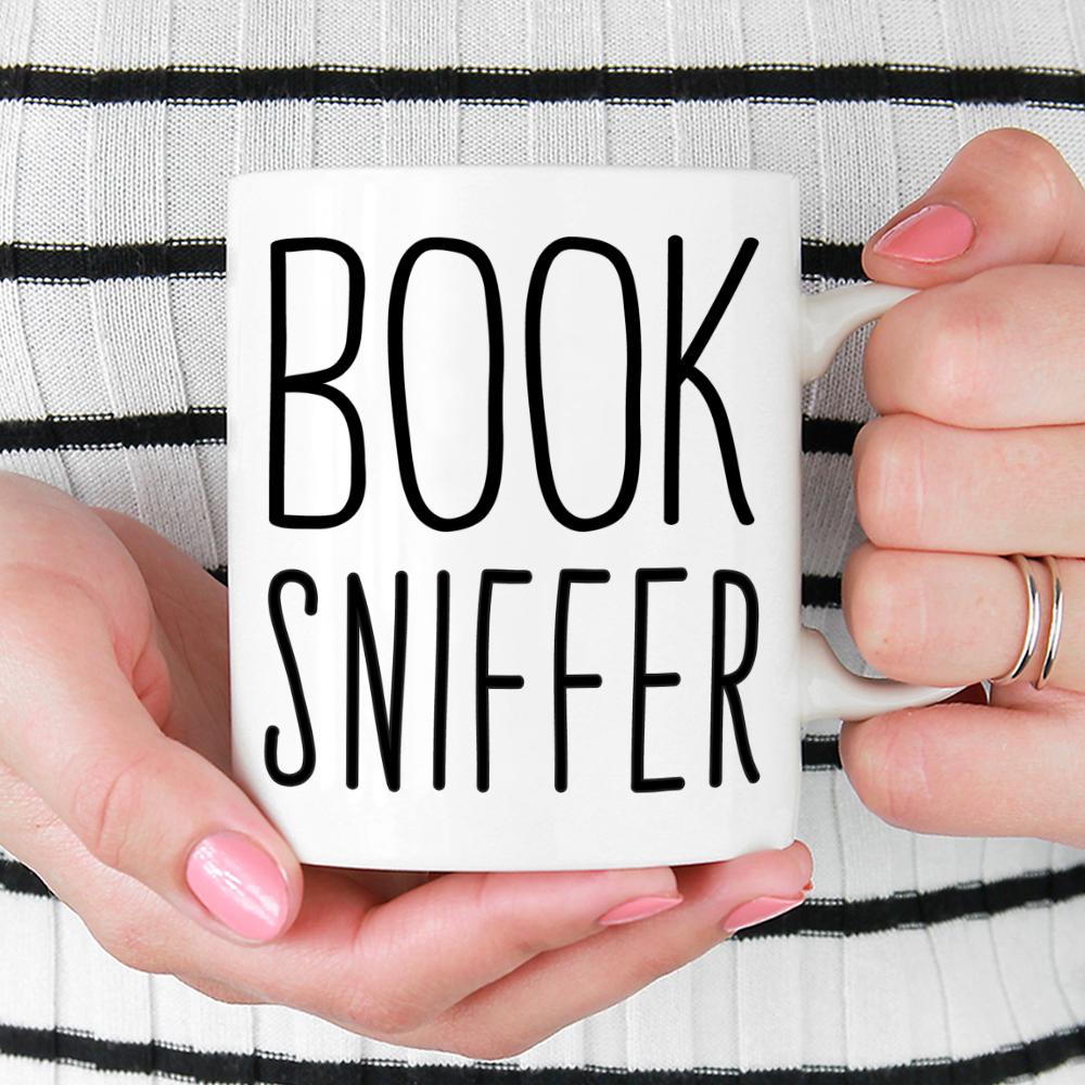 Book Sniffer Mug held by woman in black and white top with red nail polish