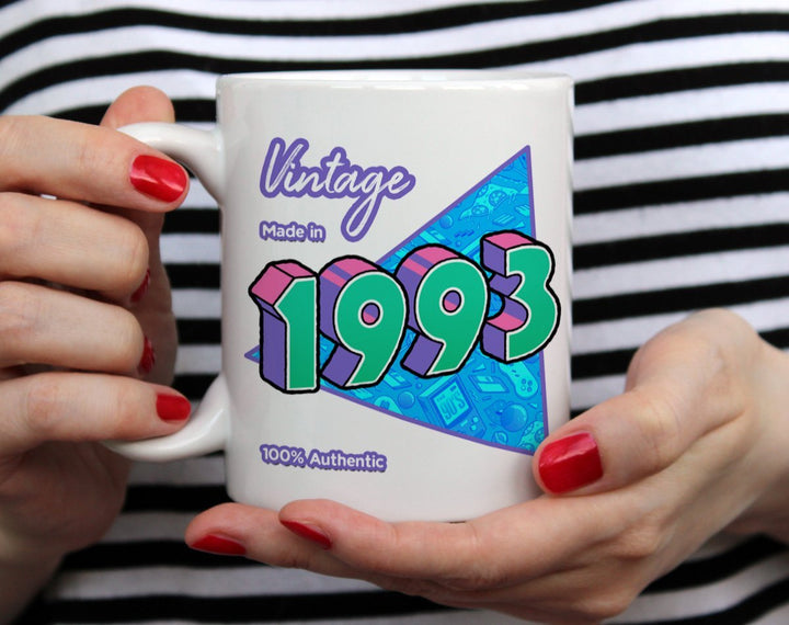 Custom Birth Year 1990's Retro Coffee Mug being held by woman wearing black and white top with red nail polish