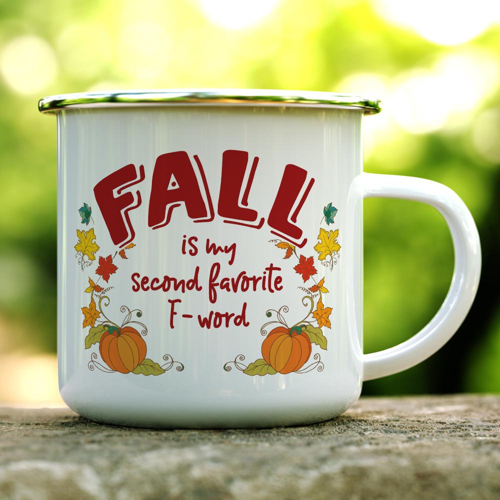 white mug with silver rim that says Fall is My Second Favorite F-Word Camp with pumpkins and leaves on white background on a log